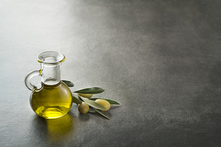 Bottle of Extra virgin healthy Olive oil with fresh olives の写真素材