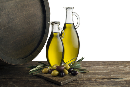 Bottles of Extra virgin healthy Olive oil with barrel background on whiteの写真素材