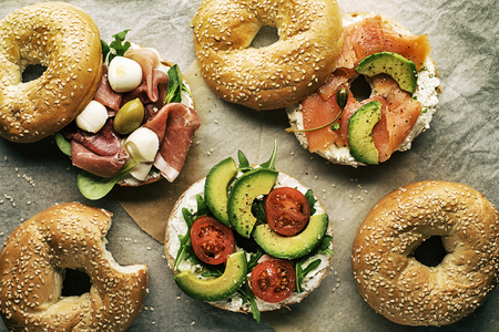 Bagel sandwich with avocado, salmon, prosciutto and mozzareela cheese. Healthy food.の写真素材