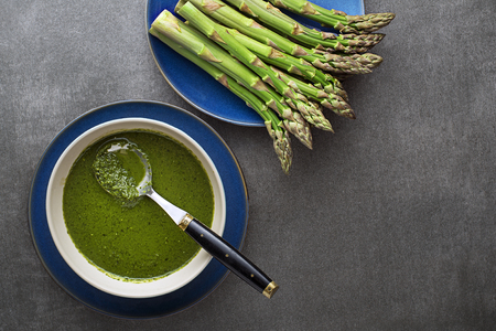 Asparagus soup meal. Healthy green soup of green asparagus, top view- Imageの写真素材