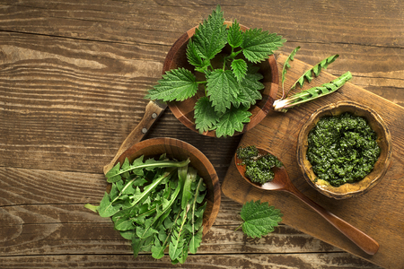 Spring healthy food. Nettle and dandelion pesto on wooden backgroundの写真素材