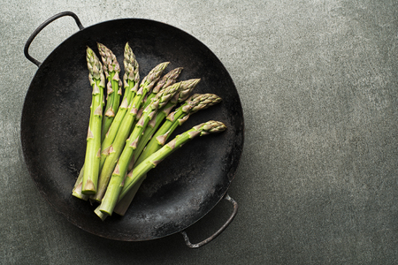 Fresh of green Asparagus. Cooking healthy meal in pan. Bunches of green asparagus, top view- Imageの写真素材