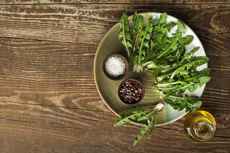 Fresh dandelion leaves on wooden background overhead shoot. Healthy natural organic food concept - Imageの写真素材