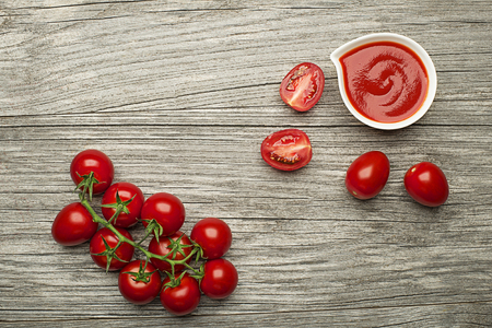 Fresh tomatoes for cooking tomato sauce or soup on wooden background place for text. Vegan food vegetarian and healthy cooking concept.の写真素材