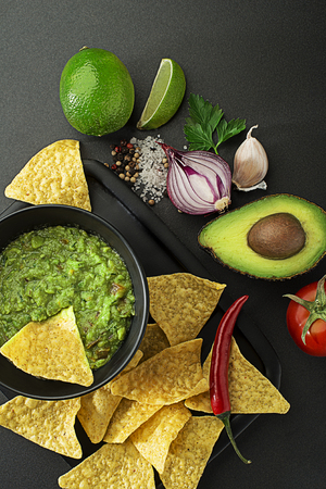 Fresh ingredients for Guacamole sauce with corn nachos chipsの写真素材