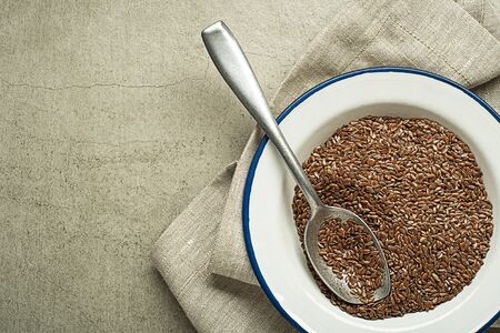 Brown flaxseed in spoon. Organic superfood for healthy eating.の写真素材