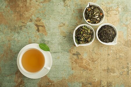 Cup of tea with dry tea collection of different types- classic black and green tea flavourの写真素材