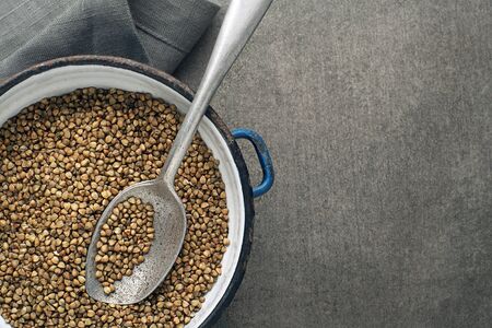 Dry buckwheat cereal grains with spoon close up.の写真素材