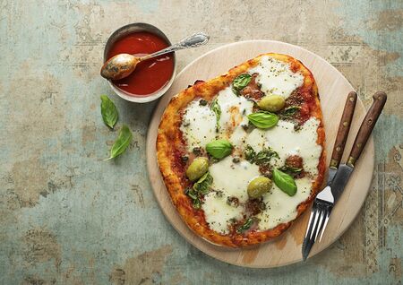 Pizza Margherita served with mozzarella cheese, tomato sauce and fresh basilの写真素材