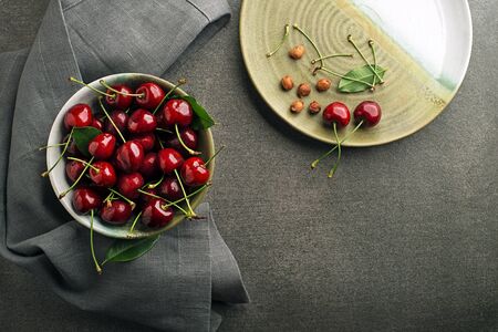 Bowl of fresh red cherries on the table close upの写真素材