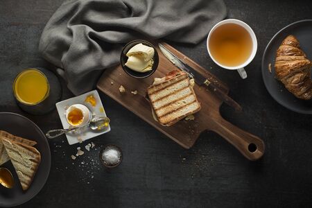Breakfast served with orange juice, croissants, egg and toast. Delicious healthy breakfast.の写真素材