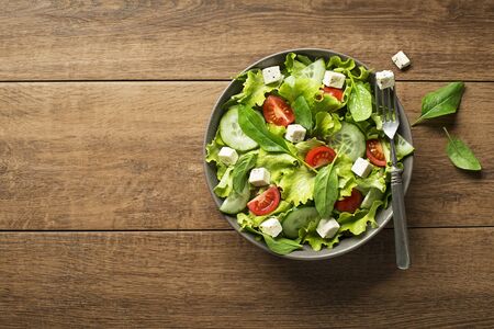 Healthy salad with spinach tomato and cheese. Home made food. Concept for a tasty and healthy meal.の写真素材