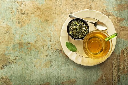 Cup of tea with dry tea - classic black and green tea flavourの写真素材
