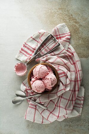Fresh of soft ice cream or frozen yoghurt with berry fruit flavours. Fruit ice cream scoop, scooped with utensilの写真素材