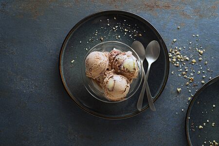 Homemade Organic Ice cream scoops with chocolate and nuts in a plate close upの写真素材