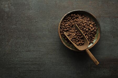 Roasted Coffee beans on dark table. Copyspace for your concept textの写真素材