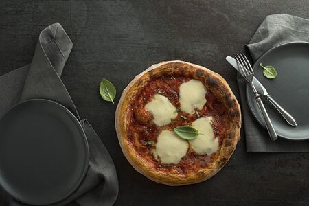 Pizza Margherita served with mozzarella cheese, tomato sauce and fresh basilの写真素材