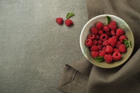 Raspberries with green leaf close up. Healthy food with fresh berry fruit.の写真素材