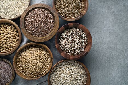 Various of healthy seeds and cereals - sesame, flax seed, chia seeds, soybean, buckwheat, psyllium, wheat and oats. Copy space.の写真素材