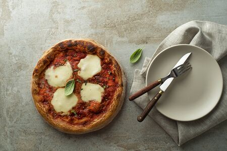 Pizza Margherita served with mozzarella cheese, tomato sauce and fresh basilの写真素材