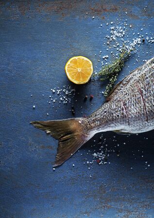 Delicious fresh fish on vintage background. Healthy diet eating or cooking conceptの写真素材