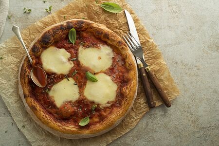 Pizza Margherita served with mozzarella cheese, tomato sauce and fresh basilの写真素材