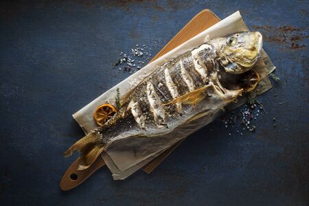 Delicious grilled fish meat with spices and lemon on vintage blueの写真素材