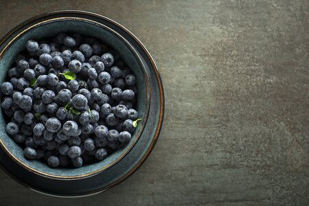 Eating Blueberry. Fresh raw berries. Agriculture, Gardening, Harvest Conceptの写真素材