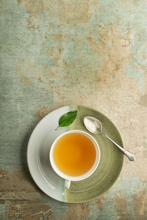 Cup of green and herbs tea served with fresh leafの写真素材