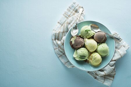 Set of soft ice cream scoops or frozen yogurt of different flavours with chocolate, nuts and fruitsの写真素材