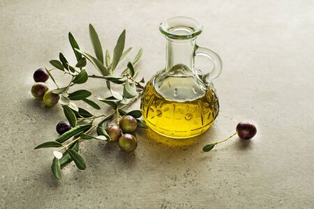 Bottle of Extra virgin healthy Olive oil with fresh olives close upの写真素材