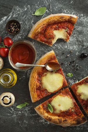Pizza Margherita slices served with mozzarella cheese, tomato sauce and fresh basilの写真素材