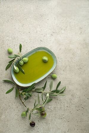 Healthy olive oil with olives and leaves background close up. Healthy conceptの写真素材