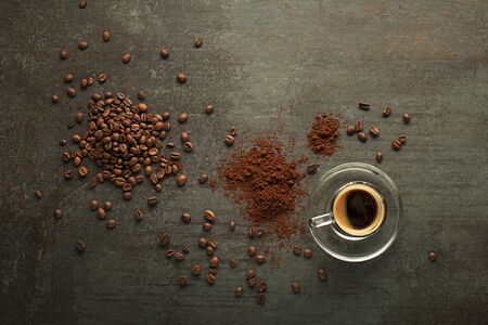 Espresso Coffee cup with beans on dark table. Copyspace for your concept text or coffee tableの写真素材