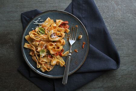 Tasty appetizing classic italian pasta with tomato sauce, cheese parmesan and basil on plate. View from aboveの写真素材