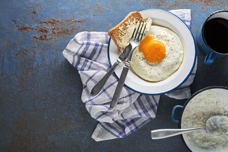 Continental Breakfast meal of fried egg, bread, coffee and oatmeal on table top view. Healthy breakfast tabel.の写真素材