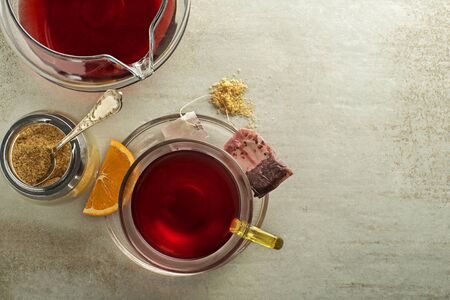 Cup of tea with sugar and teapot on grey table backgroundの写真素材