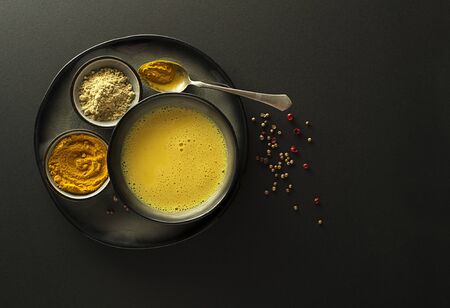 Healthy drink with curcuma and milk. Golden Milk, made with turmeric and other spicesの写真素材