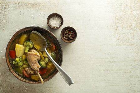 Eating healthy stew with rabbit meat and vegetables on grey background.の写真素材