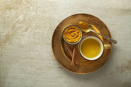 Healthy drink made from turmeric roots, spices, milk and honey. Golden Milk, made with turmeric and other spicesの写真素材