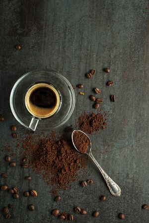 Espresso Coffee cup with beans on dark table. Copyspace for your concept text or coffee tableの写真素材