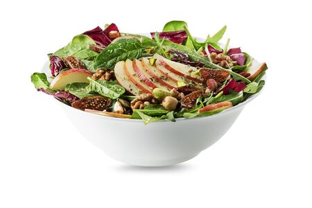 Healthy green salad with apple fruit and nuts isolated on white backgroundの写真素材