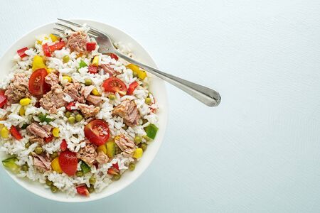 Fresh rice salad with tuna and vegetables in a bowl close up shootの写真素材