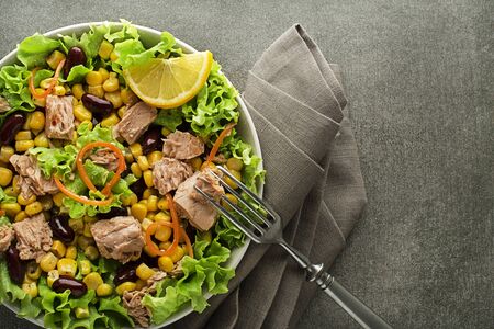 Healthy Green salad with tuna, corn and beans on grey background. Mexican corn salad.の写真素材