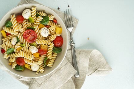 Pasta salad with mozzarella cheese and vegetables. Healthy pasta meal.の写真素材