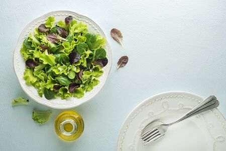 Healthy Green salad meal with fresh vegetables on blue table backgroundの写真素材