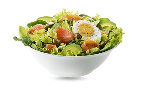Healthy green salad with salmon fish and avocado isolated on white の写真素材