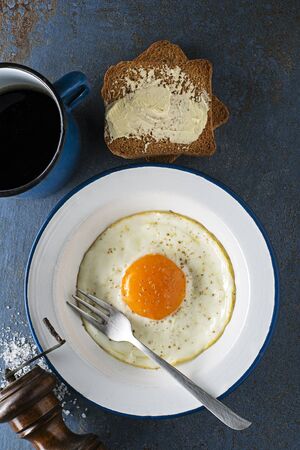 Continental Breakfast meal of fried egg served with bread and coffee top view. Healthy breakfast tabel.の写真素材