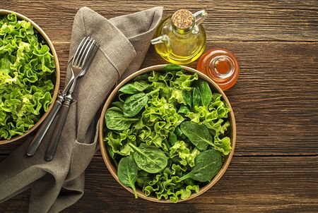 Healthy green salad on wooden table background. Healthy meal.の写真素材