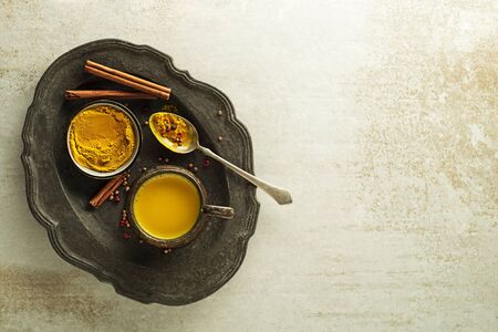 Healthy drink made from turmeric roots, spices, milk and honey. Golden Milk, made with turmeric and other spicesの写真素材